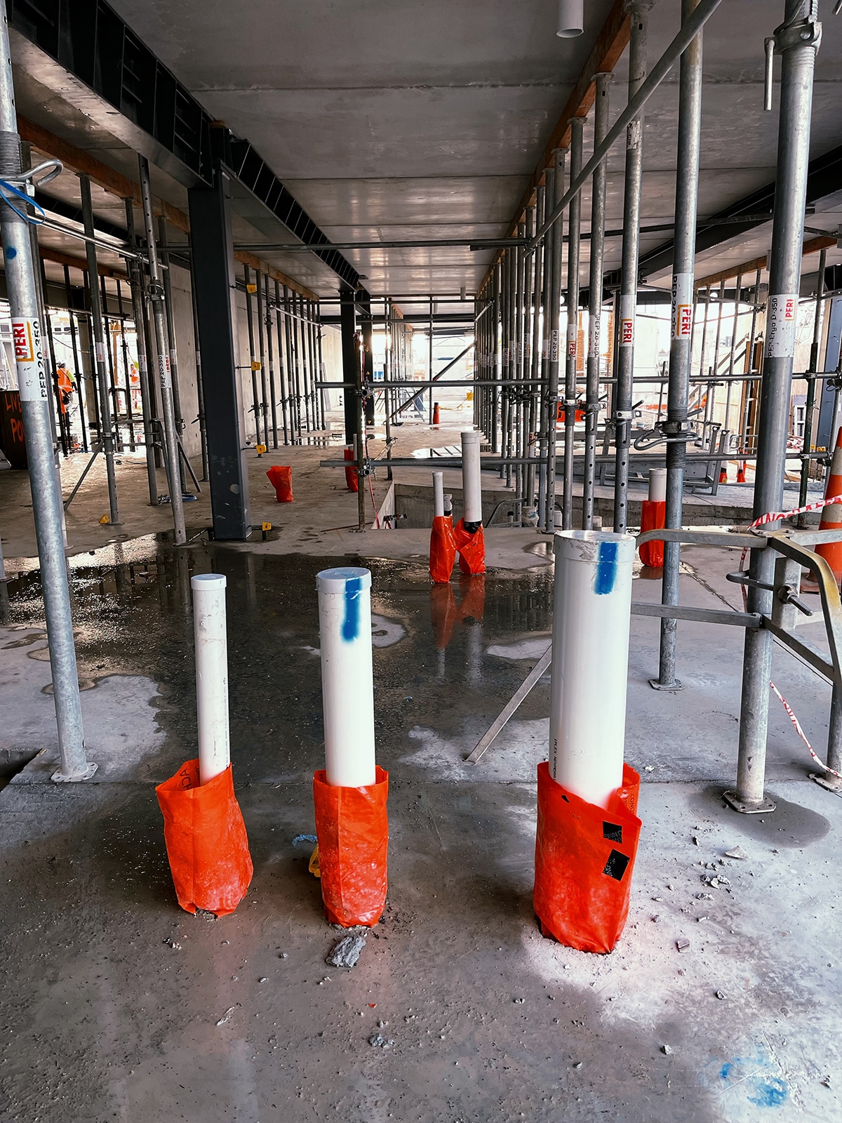 Orange Apache plumbing sleeves at a commercial construction site - Why did we pick SAFETY ORAGE as the colour of our Apache plumbing sleeves?